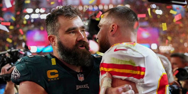 Jason Kelce #62 of the Philadelphia Eagles speaks with Travis Kelce #87 of the Kansas City Chiefs after Super Bowl LVII at State Farm Stadium on February 12, 2023, in Glendale, Arizona. The Chiefs defeated the Eagles 38-35. 