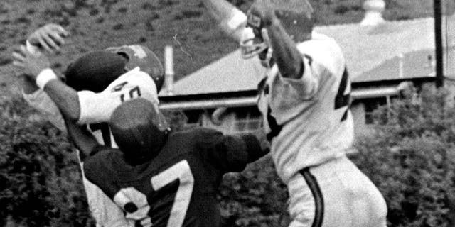 Lionel Taylor, #87, is sandwiched by two defenders on a pass play, Jim McMillin, left, nearly made an interception but couldn't hold on to the ball in a Broncos intrasquad game on Sunday in July 1966.