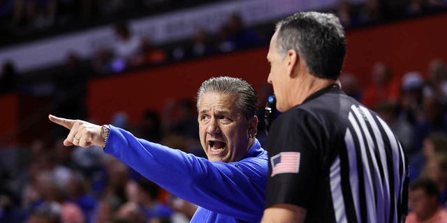 Kentucky Wildcats head coach John Calipari speaks to a referee during the first half of a game against the Florida Gators at the Stephen C. O'Connell Center on February 22, 2023 in Gainesville, Florida.