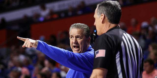 Kentucky Wildcats head coach John Calipari speaks to a referee during the first half of a game against the Florida Gators at the Stephen C. O'Connell Center on February 22, 2023 in Gainesville, Florida.