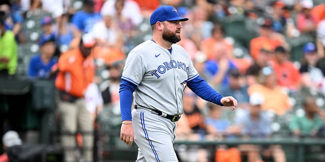 Interim manager John Schneider #14 of the Toronto Blue Jays crosses the field during the game against the Baltimore Orioles at Oriole Park at Camden Yards during game one of a double header on September 5, 2022, in Baltimore, Maryland.