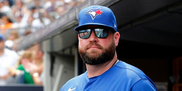 Manager John Schneider #14 of the Toronto Blue Jays looks on before a game against the New York Yankees at Yankee Stadium on August 21, 2022, in New York City. The Yankees defeated the Blue Jays 4-2.