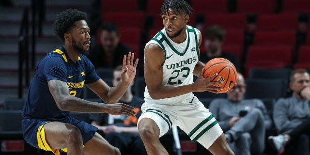Jorell Saterfield (23) of the Portland State Vikings handles the ball against Kobe Johnson (2) of the West Virginia Mountaineers at Moda Center Nov. 25, 2022, in Portland, Ore.