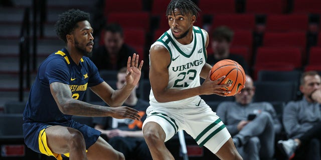 Jorell Saterfield (23) of the Portland State Vikings handles the ball against Kobe Johnson (2) of the West Virginia Mountaineers at the Moda Center on November 25, 2022 in Portland, Oregon.