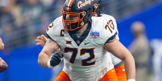 Oklahoma State Cowboys offensive lineman Josh Sills, #72, during the 2022 Fiesta Bowl against the Notre Dame Fighting Irish at State Farm Stadium in Glendale, Arizona, January 1, 2022.
