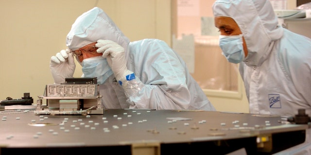 Ball Aerospace &amp; Technologies Corp. engineers Greg Hillen (left) and Raul Martinez work on the back plate for the Schmidt corrector plate, a lens used to correct spherical aberration in a reflecting telescope in NASA's Kepler Mission. 