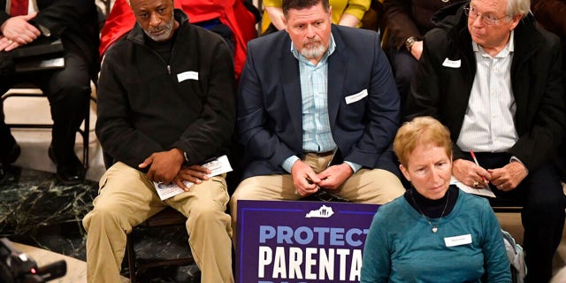 Members of the Faith and Family advocacy group, listen to speakers during a rally in the rotunda of the Kentucky State Capitol in Frankfort, Ky., Thursday, Feb. 16, 2023.