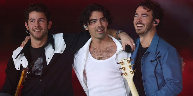 From left to right, Nick Jonas, Joe Jonas, and Kevin Jonas of the Jonas Brothers perform in the halftime show during the game between the Dallas Cowboys and the New York Giants at AT&T Stadium on Nov. 24, 2022 in Arlington, Texas.