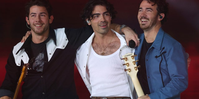 From left to right, Nick Jonas, Joe Jonas, and Kevin Jonas of the Jonas Brothers perform in the halftime show during the game between the Dallas Cowboys and the New York Giants at AT&T Stadium on Nov. 24, 2022 in Arlington, Texas.
