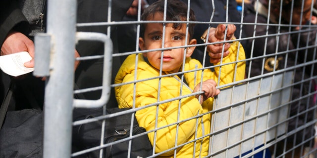 Syrians wait to cross into Syria from Turkey at the Cilvegozu border gate, near the town of Antakya, southeastern Turkey, Tuesday, Feb. 21, 2023.