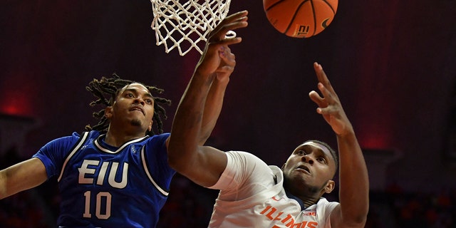 Eastern Illinois Panthers guard Kinyon Hodges, #10, and Illinois Fighting Illini forward Dain Dainja, #42, battle for a rebound during the second half at State Farm Center in Champaign, Illinois, Nov. 7, 2022.