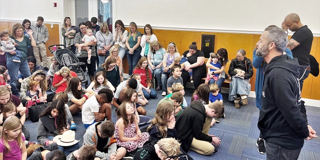 Kirk Cameron, standing at right, leads a crowd in Savannah, Georgia, in prayer on Thursday, Feb. 9.