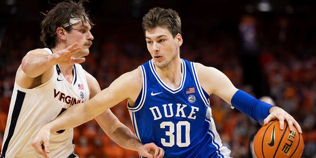 Duke's Kyle Filipowski (30) drives against Virginia's Ben Vander Plas (5) during the first half of a game in Charlottesville, Virginia on Saturday, February 11, 2023. 