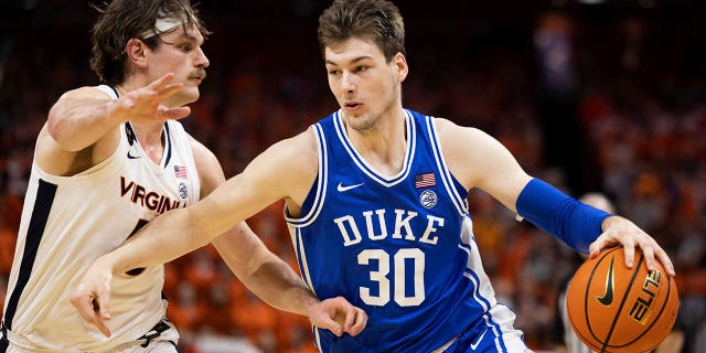 Duke's Kyle Filipowski (30) drives against Virginia's Ben Vander Plas (5) during the first half of a game in Charlottesville, Va., Saturday, Feb. 11, 2023. 