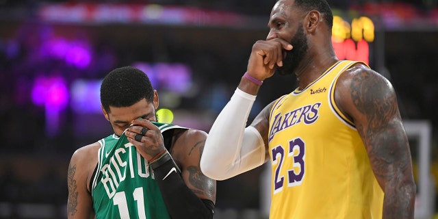Kyrie Irving of the Boston Celtics and LeBron James of the Lakers enjoy a lighter moment at the Staples Center on March 9, 2019, in Los Angeles.