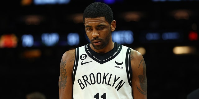 Brooklyn Nets guard Kyrie Irving reacts against the Phoenix Suns in the first half at the Footprint Center on January 19, 2023 in Phoenix, Arizona. 