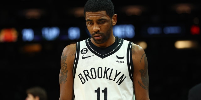 Brooklyn Nets guard Kyrie Irving reacts against the Phoenix Suns in the first half at the Footprint Center on January 19, 2023 in Phoenix, Arizona. 