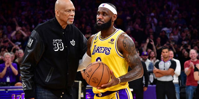 Los Angeles Lakers forward LeBron James (6) meets with former player Kareem Abdul-Jabbar after breaking the NBA all time scoring record against the Oklahoma City Thunder during the second half at Crypto.com Arena. 