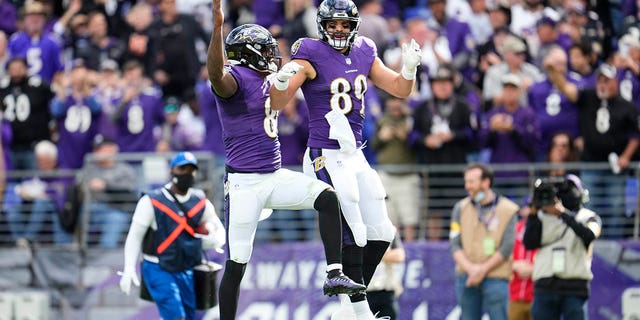  Lamar Jackson #8 of the Baltimore Ravens celebrates with tight end Mark Andrews (89) during to an NFL game against the Los Angeles Chargers at M&amp;T Bank Stadium on October 17, 2021, in Baltimore, Maryland.