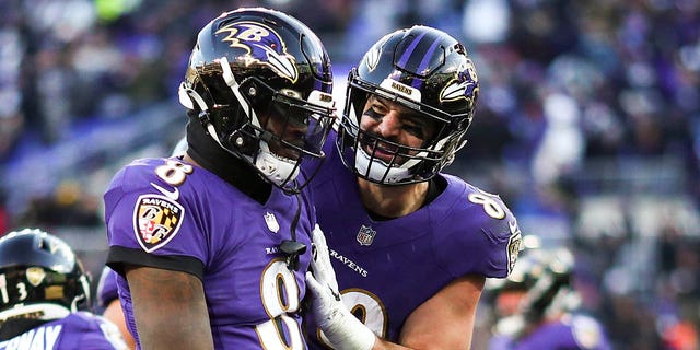 Lamar Jackson, #8 of the Baltimore Ravens, celebrates with Mark Andrews, #89, after scoring a touchdown during the fourth quarter of an NFL football game against the Carolina Panthers at M&amp;T Bank Stadium on November 20, 2022, in Baltimore, Maryland.