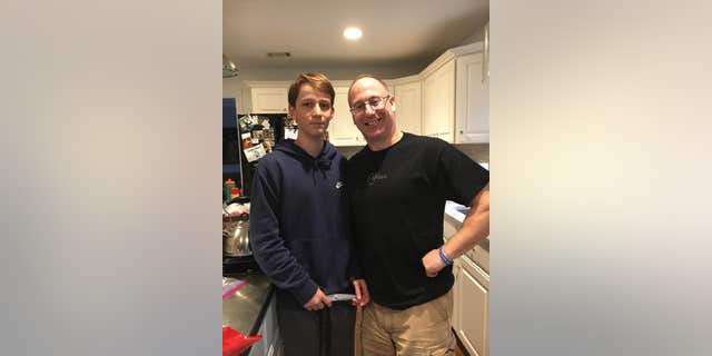 Landen Hausman and his dad, Marc Hausman, at home in Maryland.