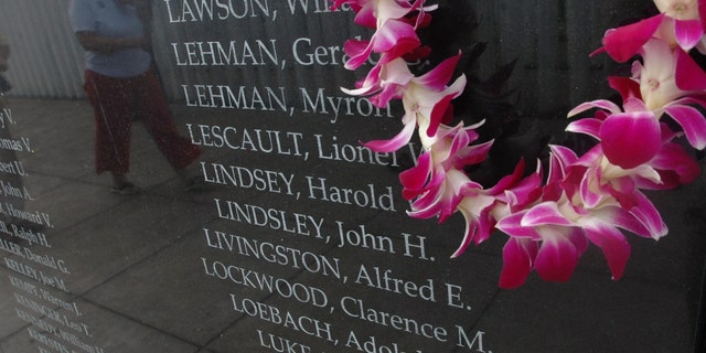 An orchid lei is drapped to the side of the new USS Oklahoma memorial during the commemoration marking the 66th anniversary of Pearl Harbor attack December 7, 2007, in Pearl Harbor, Hawaii.