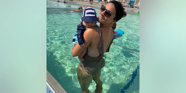 woman and son in bathing suits in pool
