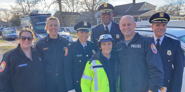 Louise Kobs (center, in front) could always be found at her corner wearing the traditional crossing guard uniform. Nassau County Police Commissioner Patrick Ryder (second from right) stands beside Kobs along with Nassau County Police Department officers on Long Island, New York.