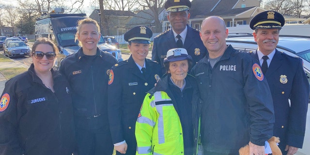 Louise Kobs (center, in front) could always be found at her corner wearing the traditional crossing guard uniform. Nassau County Police Commissioner Patrick Ryder (second from right) stands beside Kobs along with Nassau County Police Department officers on Long Island, New York.