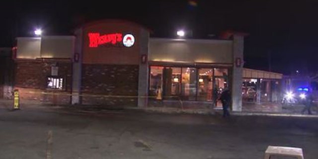 Police block off the parking lot of a Wendy's in Massachusetts as they investigate a shooting.