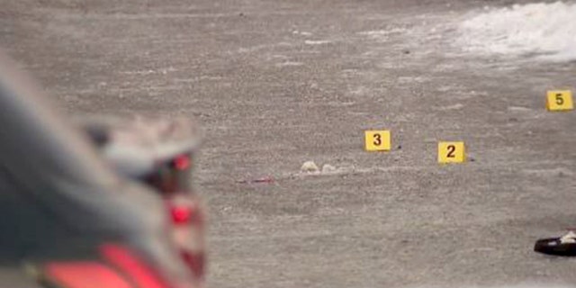 Bullet casing markers on the ground in the parking lot of a shooting after a celebration of life in Minnesota. 