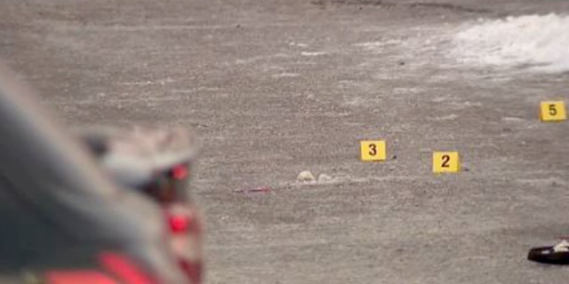 Bullet casing markers on the ground in the parking lot of a shooting after a celebration of life in Minnesota. 