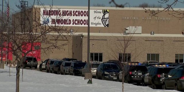 Police cars at the scene of a fatal stabbing in Harding High School in St. Paul, Minnesota where a student was killed and another was arrested.