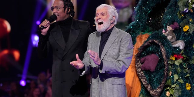 Dick Van Dyke, right, alongside Nick Cannon for his reveal on "The Masked Singer." Van Dyke performed on the show at 97 years old.