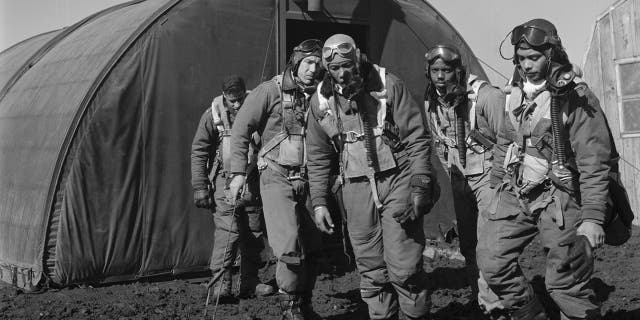 Tuskegee airmen exiting the parachute room, Ramitelli, Italy, in March 1945. Left to right, Richard S. "Rip" Harder, Brooklyn, New York; unidentified airman; Thurston L. Gaines, Jr., Freeport, New York; Newman C. Golden, Cincinnati, Ohio; Wendell M. Lucas, Fairmont Heights, Maryland. Photo by Toni Frissell Collection (Library of Congress).