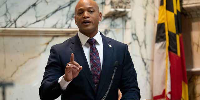 Gov. Wes Moore speaking with Maryland flag at right