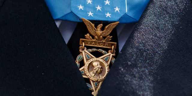 The Medal of Honor is seen around the neck of Medal of Honor recipient Army Staff Sgt. David Bellavia outside the West Wing of the White House in Washington, June 25, 2019. One of the first Black officers to lead a Special Forces team in combat will receive the Medal of Honor, the nation's highest award for bravery on the battlefield, nearly 60 years after he distinguished himself during the Vietnam War. President Joe Biden telephoned ret. U.S. Army Col. Paris Davis on Monday, Feb. 13, 2023, "to inform him that he will receive the Medal of Honor for his remarkable heroism during the Vietnam War." (AP Photo/Carolyn Kaster, File)