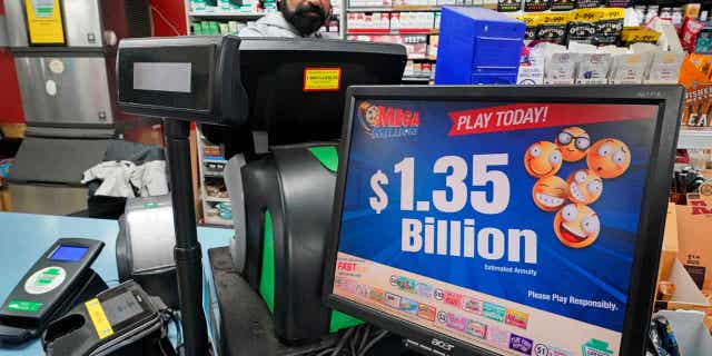 A Mega Millions sign displays the estimated jackpot of $1.35 Billion at a store in Cranberry, Pennsylvania, on Jan. 12, 2023. The winner of the jackpot has come forward to collect the prize.
