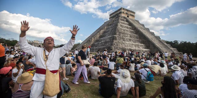 People surround the Kukulcan Pyramid at the Mayan archaeological site of Chichen Itza in Yucatan State, Mexico, during the celebration of the spring equinox on March 21, 2022. 