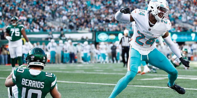 Byron Jones of the Miami Dolphins reacts after breaking up a touchdown pass against the New York Jets at MetLife Stadium on November 21, 2021 in East Rutherford, New Jersey.