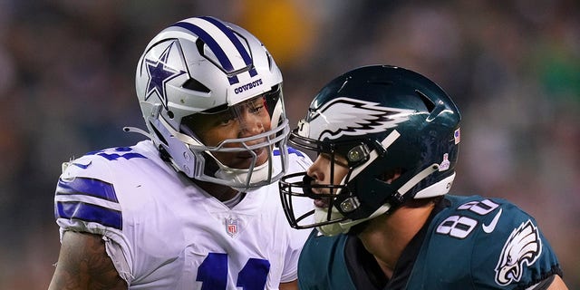 Micah Parsons #11 of the Dallas Cowboys speaks with Dallas Goedert #88 of the Philadelphia Eagles at Lincoln Financial Field on October 16, 2022 in Philadelphia, Pennsylvania.