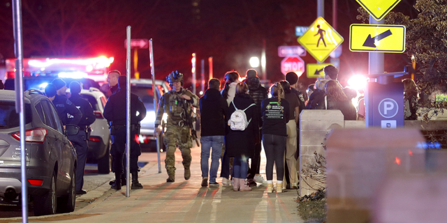 Students gather on the campus of Michigan State University after a shelter in place order was lifted early Tuesday, Feb. 14, in East Lansing, Michigan.