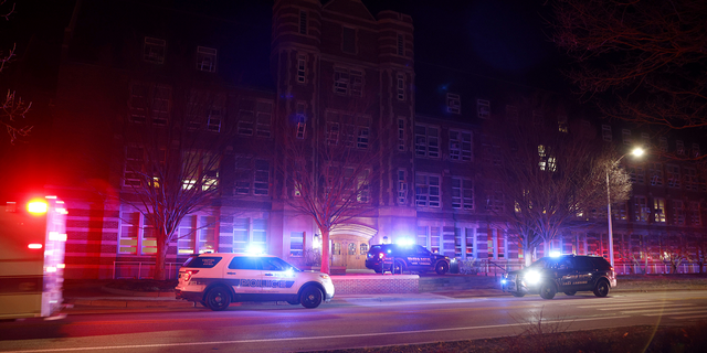 First responders pose outside Berkey Hall following the shootings on the Michigan State University campus on Monday, February 13.