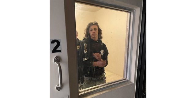Miles Pfeffer in Philadelphia police custody in a holding cell. 