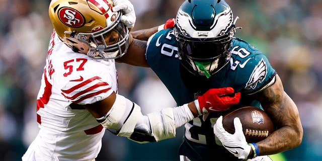 Miles Sanders (26) of the Philadelphia Eagles stiff-arms Dre Greenlaw (57) of the San Francisco 49ers while carrying the ball during the second quarter of the NFC championship game at Lincoln Financial Field Jan. 29, 2023, in Philadelphia.