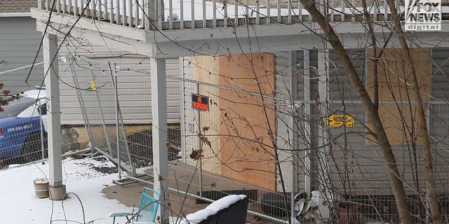 The back door where suspected killer Bryan Kohberger is alleged to have exited the crime scene is also boarded up.