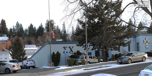 The University of Idaho's Sigma Chi fraternity house, where Ethan Chapin was a member, stands in the foreground of the boarded-up King Road crime scene in Moscow, Idaho, on Feb. 23, 2023.