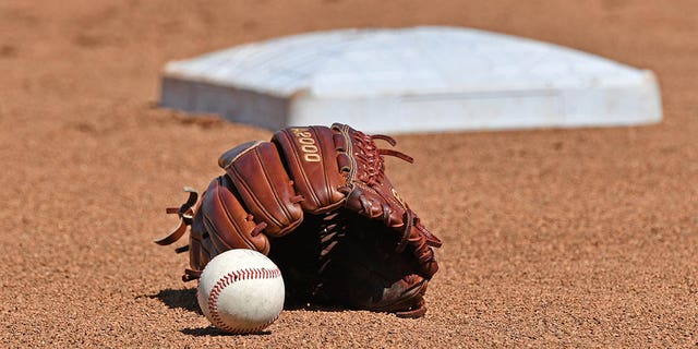 A general view of a baseball and glove in the field prior to Game 1 of the College World Series Championship Series between the Michigan Wolverines and Vanderbilt Commodores on June 24, 2019, at TD Ameritrade Park in Omaha, Nebraska.