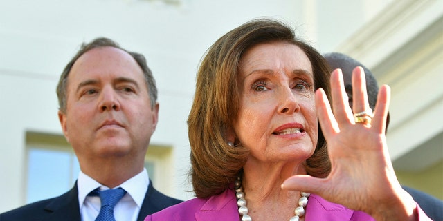 FILE - Rep. Adam Schiff, D-Calif., listens as Speaker of the House Nancy Pelosi speaks to reporters following a meeting with President Biden at the White House in Washington, D.C, on May 10, 2022.