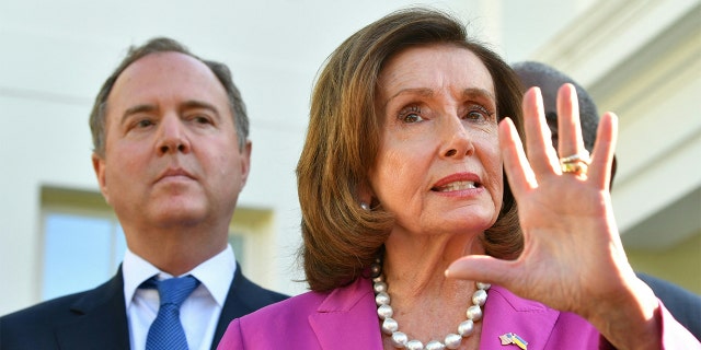 FILE - Rep. Adam Schiff, D-Calif., listens as Speaker of the House Nancy Pelosi speaks to reporters following a meeting with President Biden at the White House in Washington, D.C, on May 10, 2022.